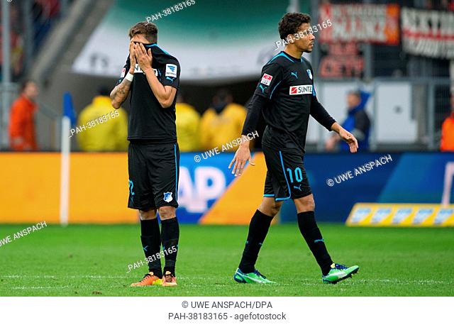 Hoffenheim's Roberto Firmino (L) and Igor de Camargo leave the pitch after the 0-0 in the German Bundesliga match between TSG 1899 Hoffenheim and 1