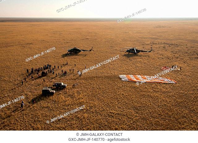 Ground support personnel are seen at the landing site after the Soyuz TMA-12M spacecraft landed with Expedition 40 Commander Steve Swanson of NASA