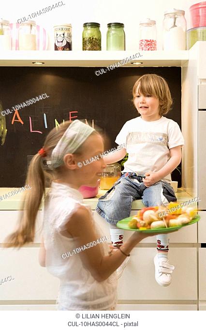 Girl and boy cooking vegetables