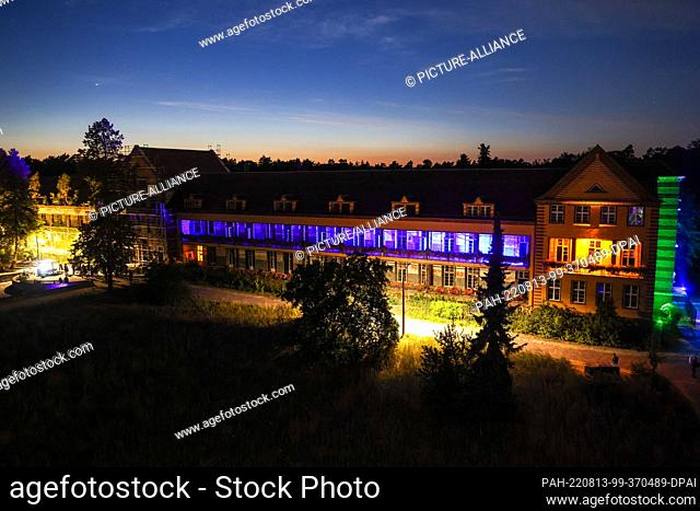12 August 2022, Brandenburg, Beelitz-Heilstätten: The illuminated surgery building at the ""Long Nights at the Treetop Trail"" event in Beelitz-Heilstätten