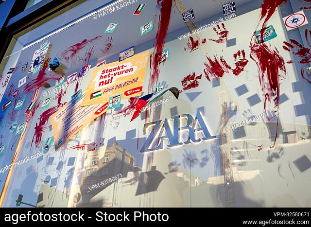 Illustration picture shows protesters smearing red paint on the store front windows of a Zara clothes chain shop, in Brussels