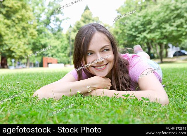 Woman is lying in a meadow