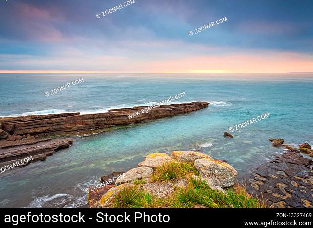 Morning light over Culburra from a narrow precipice looking out over the rocks and ocean