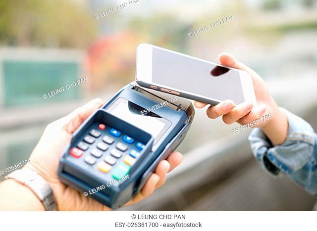 Customer using mobile phone for pay by the bill