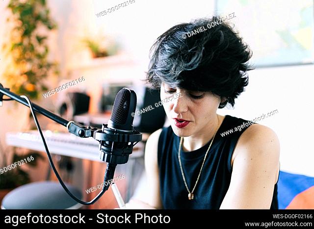 Female musician singing while recording at studio