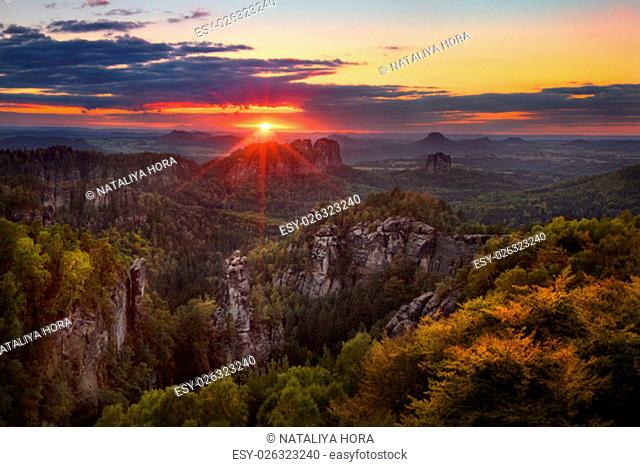 colorful sunset view on Schrammsteine from Carolafelsen in the national park Saxon Switzerland, Germany
