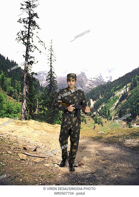Indian army soldier Ak-47 machine gun in hand mountain in background MR