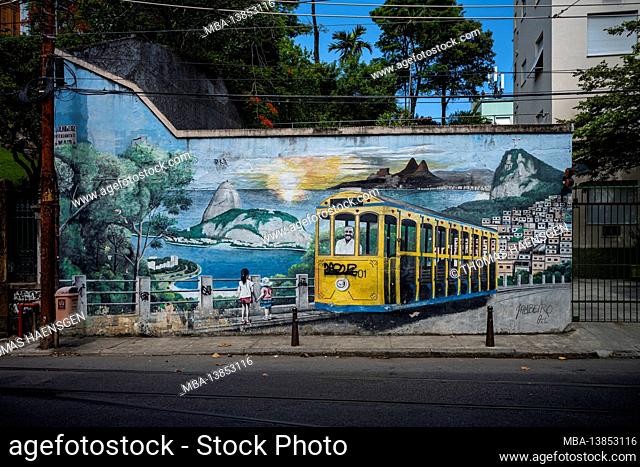 Colorful street art depicting a bond tram driving above the city skyline decorates a wall in the Santa Teresa neighborhood