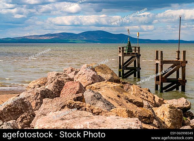 The entrance to the harbour with the coast of Scotland in the background, seen from the West Beach in Silloth, Cumbria, England, UK