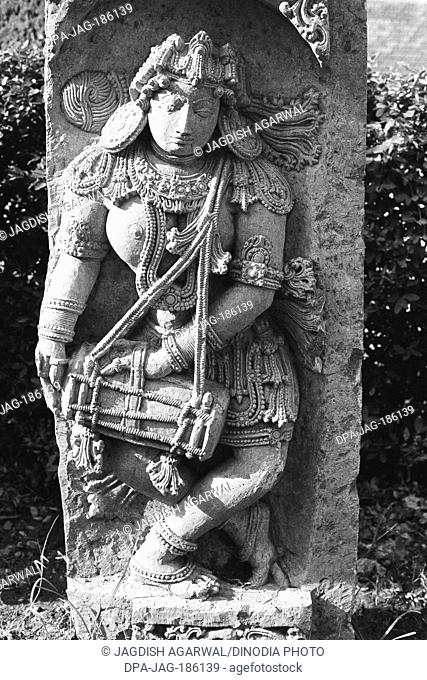 Man playing drums wall relief sculpture Halebid Mysore Karnataka India Asia 1977