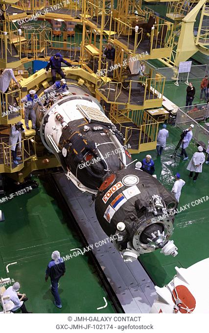 At the Integration Facility at the Baikonur Cosmodrome in Kazakhstan, engineers swarm over the Soyuz TMA-08M spacecraft March 22 as they prepare the vehicle for...
