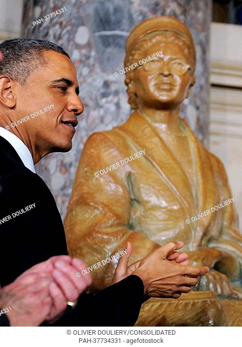 United States President Barack Obama looks on during the unveiling of a statue of Rosa Parks in Statuary Hall of the United States Capitol February 27
