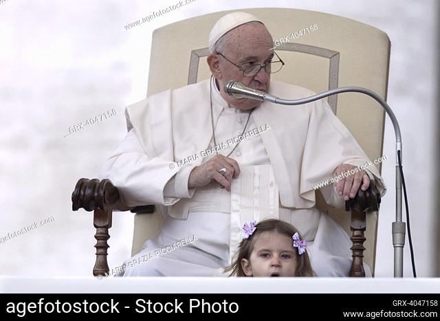 Vatican City, Vatican, 9 November 2022. A little girl sits next to Pope Francis during his weekly general audience in St. Peter's Square