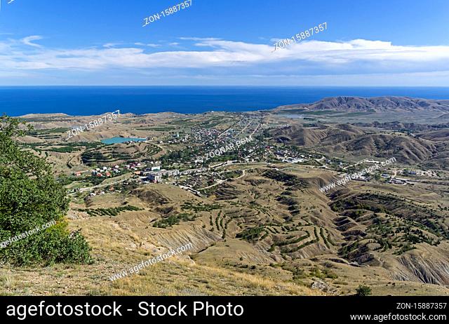 View of the village of Sunny Valley from the slope of the Tokluk mountain range. Crimea, sunny day in September