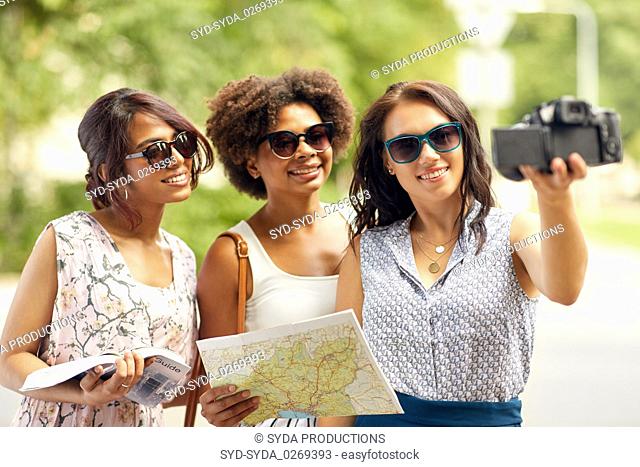 women with map travelling and recording video blog