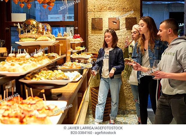 Group of young people eating "Pintxos" at the Meson Portaletas, Parte Vieja, Old town, Donostia, San Sebastian, Gipuzkoa, Basque Country, Spain