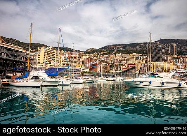 Monaco principality skyline as seen from Port Hercule, yachts and sailing boats on Mediterranean Sea, Europe