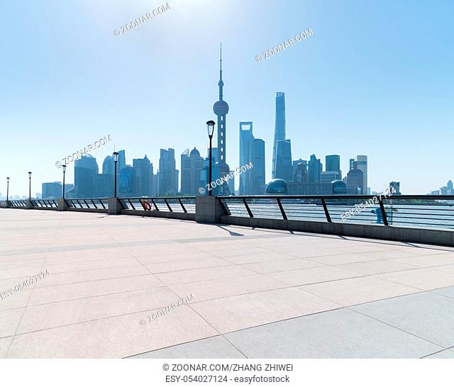 shanghai skyline in daytime, empty floor and railings on huangpu riverside