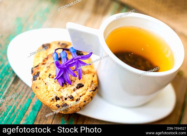 Cup of fresh herbal tea with mint on wooden table