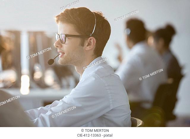Businessman wearing headset in office