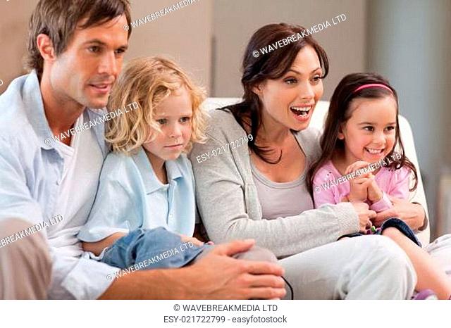 Cheerful family watching television together