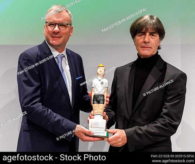 28 October 2022, Bavaria, Nuremberg: Former coach of the German national soccer team Joachim Löw (right) receives the Walther Bensemann Award of the German...