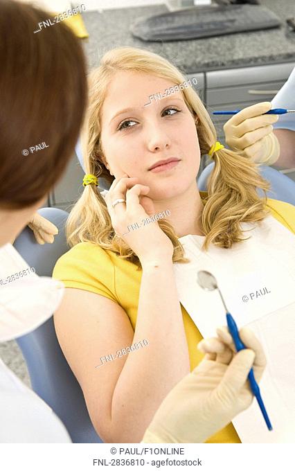 Female dentist examining patient