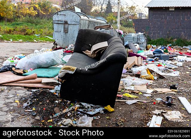 Belgrade, Serbia - November 17, 2022: Garbage pile beside dumpster scattered all over the street in Belgrade, Serbia