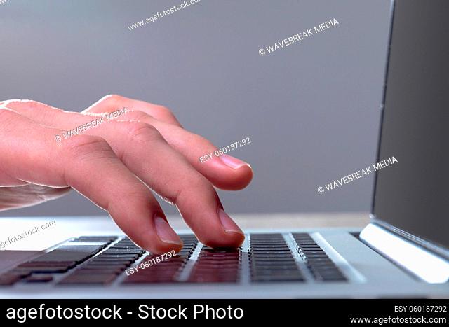 Close up of caucasian businessman typing on keyboard, isolated on grey background