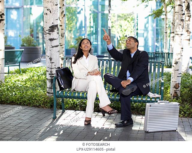 Two Businesspeople Looking Up in Park