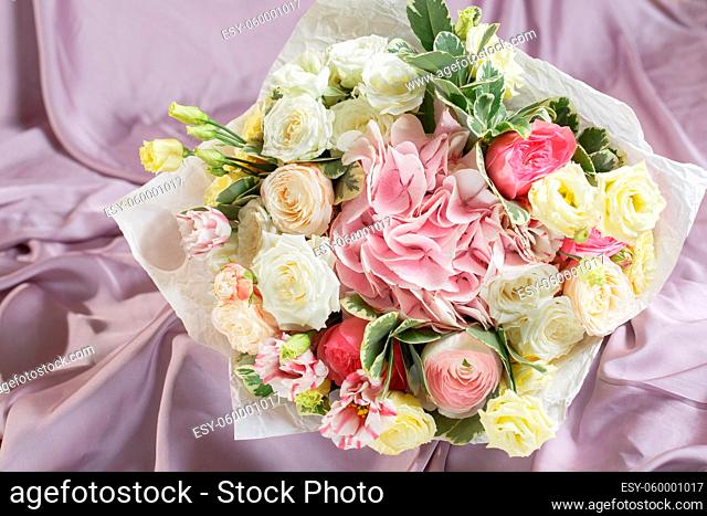 beautiful bouquet made of different flowers. colorful color mix flower on a table covered with a cloth