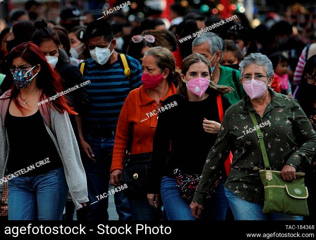 MEXICO CITY, MEXICO - DECEMBER 18, 2020: Persons wears protective masks while make christmas shopping at Historic Center