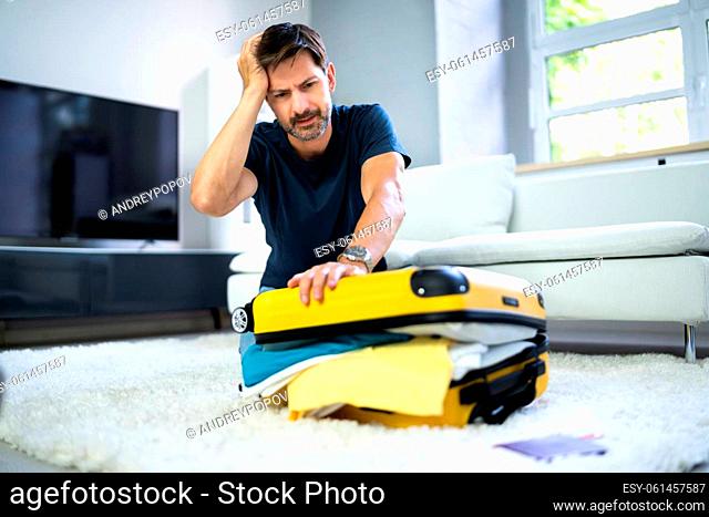 Man Packing Stuffed Suitcase Bag For Travel