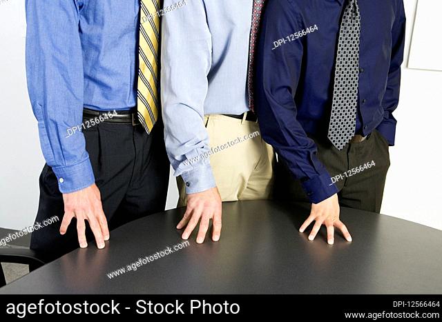 Midsection of mid adult men standing together