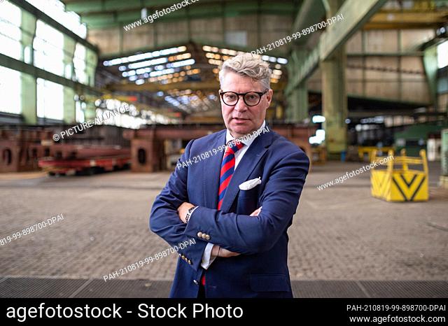 19 August 2021, Hamburg: Dr Achim Ahrendt, provisional insolvency administrator of the Pella Sietas shipyard, stands in front of components of a ship after the...