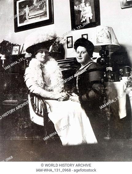 Tsarina of Russia, Alexandra of Russia, talks with a courtier. Behind her is her faithful companion Anna Vyrubova. Alexandra Feodorovna (1872 - 17 July 1918)...