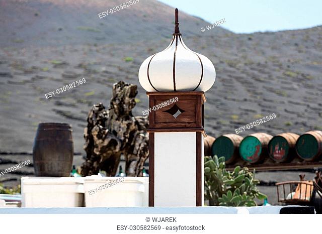 Wine barrels on background vines and mountains , Lanzarote; Canary islands