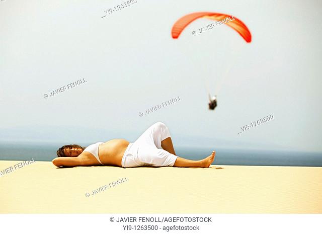 Pregnant woman relaxing on the beach