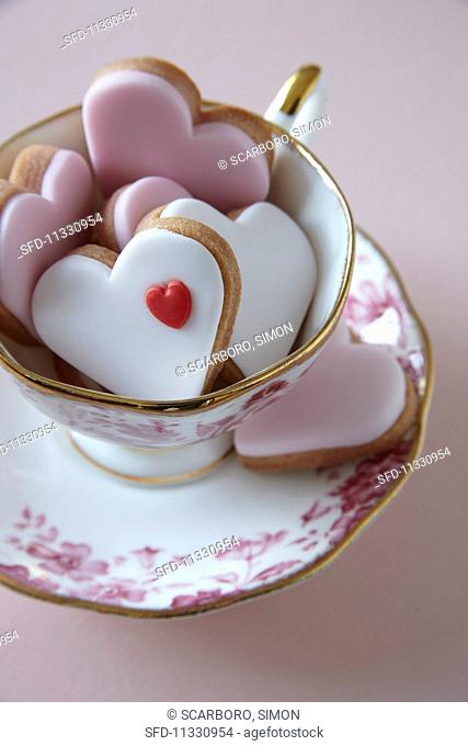 Heart-shaped biscuits in a teacup for Valentine's Day