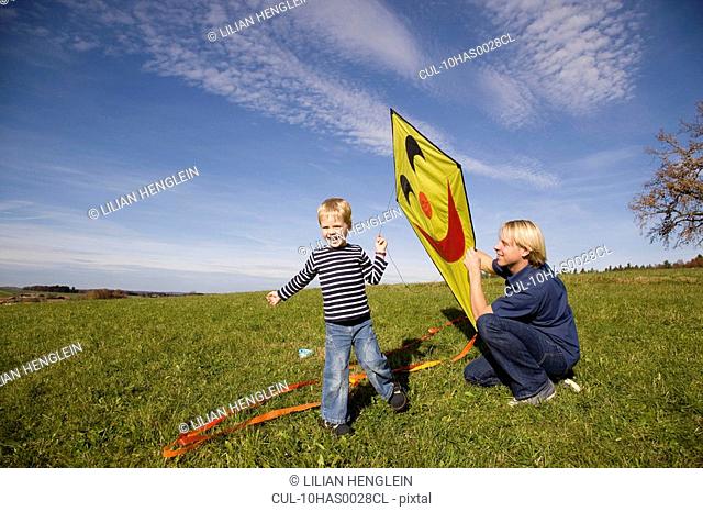 Boy and father start a Kite