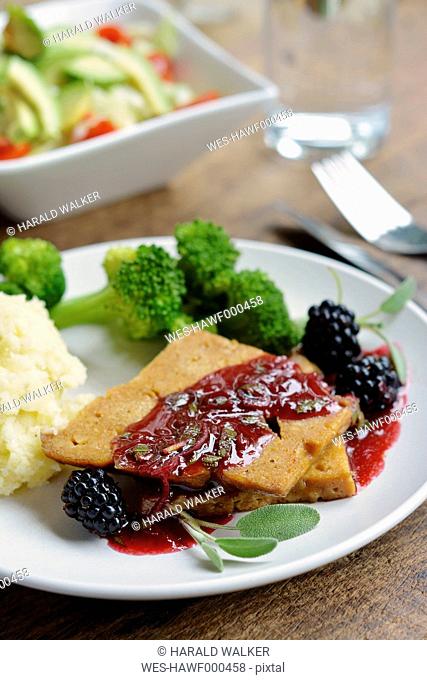 Seitan fillets with a blackberry sage sauce, mashed potatoes and broccoli