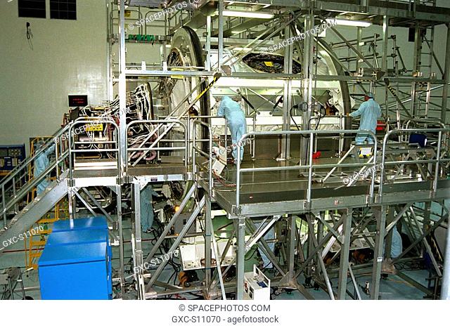 12/09/1997 --- The International Space Station's Node 1 and Pressurized Mating Adapter-1 PMA-1 are rotated by workers in KSC's Space Station Processing Facility