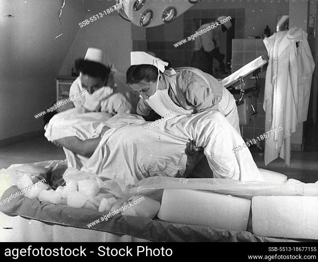 After two hours the patient, very nearly frozen, is lifted to the operating table. February 19, 1955. (Photo by Hubmann, Black Star)