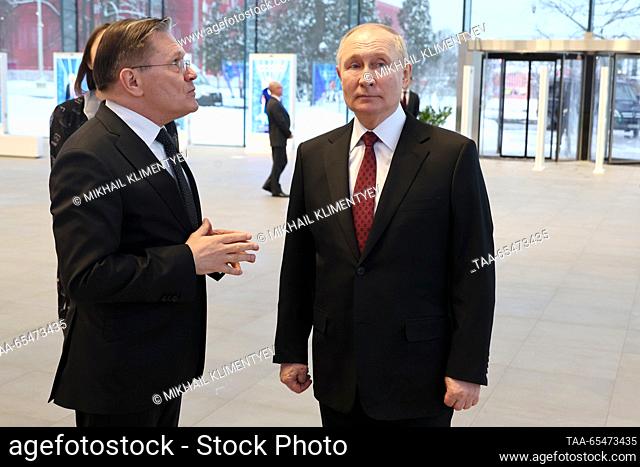 RUSSIA, MOSCOW - DECEMBER 4, 2023: Rosatom head Alexei Likhachev (L) and Russia's President Vladimir Putin are seem at the Atom Pavilion at the Russia Expo...