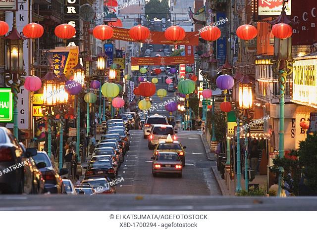 Glowing lanterns hang over Grant Avenue in Chinatown during dusk, San Francisco, California, USA