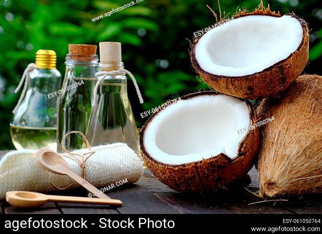 Nature cosmetic products, coconut oil from copra in glass jar on green background, essential oil for skin care, rich vitamin