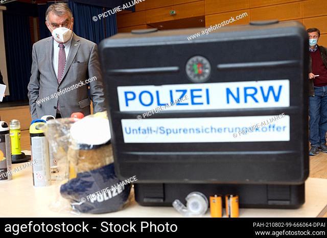 02 August 2021, North Rhine-Westphalia, Cologne: Herbert Reul (CDU), Minister of the Interior of North Rhine-Westphalia, stands in front of a forensics case of...