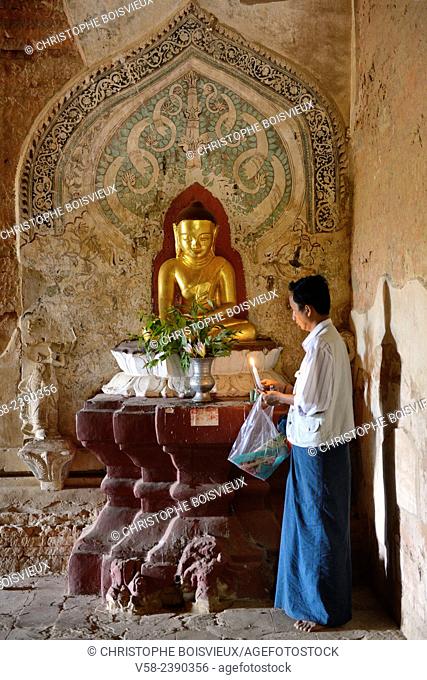 Myanmar, Bagan, Sulamani pagoda, Devotee offering a candlelight to the Buddha
