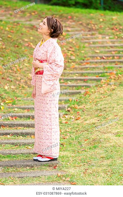 attractive asian woman wearing traditional Japanese Kimono