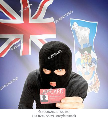 Hacker with flag on background holding ID card in hand - Falkland Islands